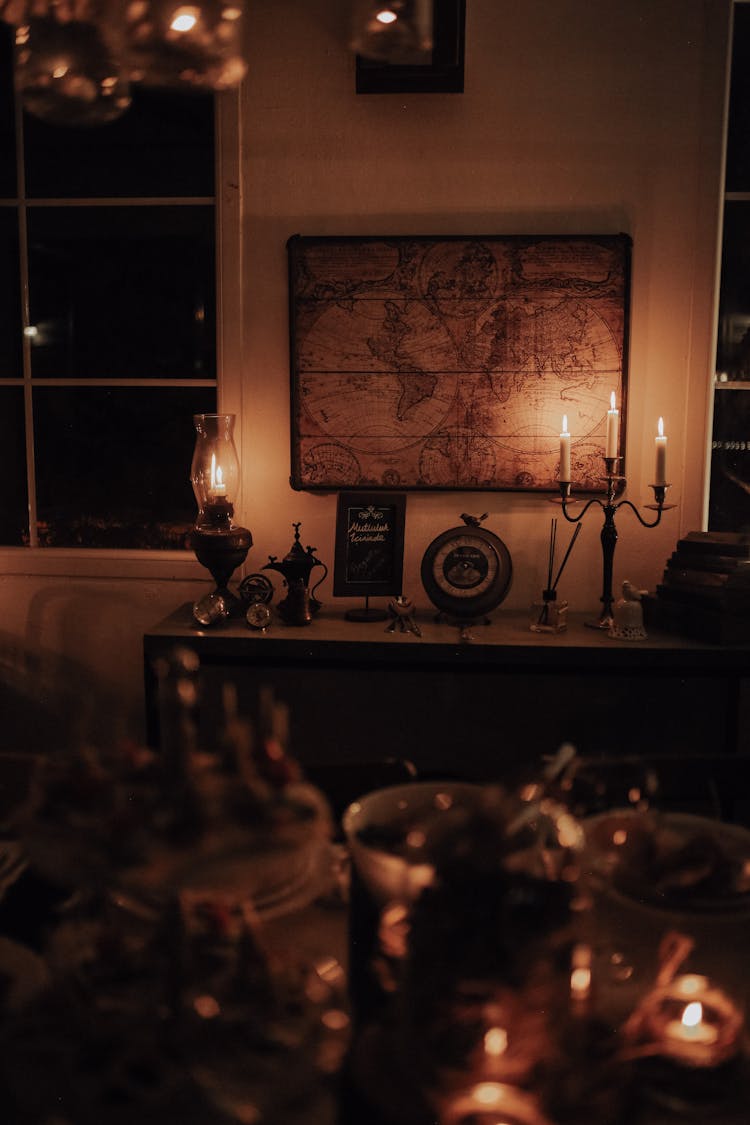 Framed Vintage Map Hanging Above Cupboard In Dimly Lit Room