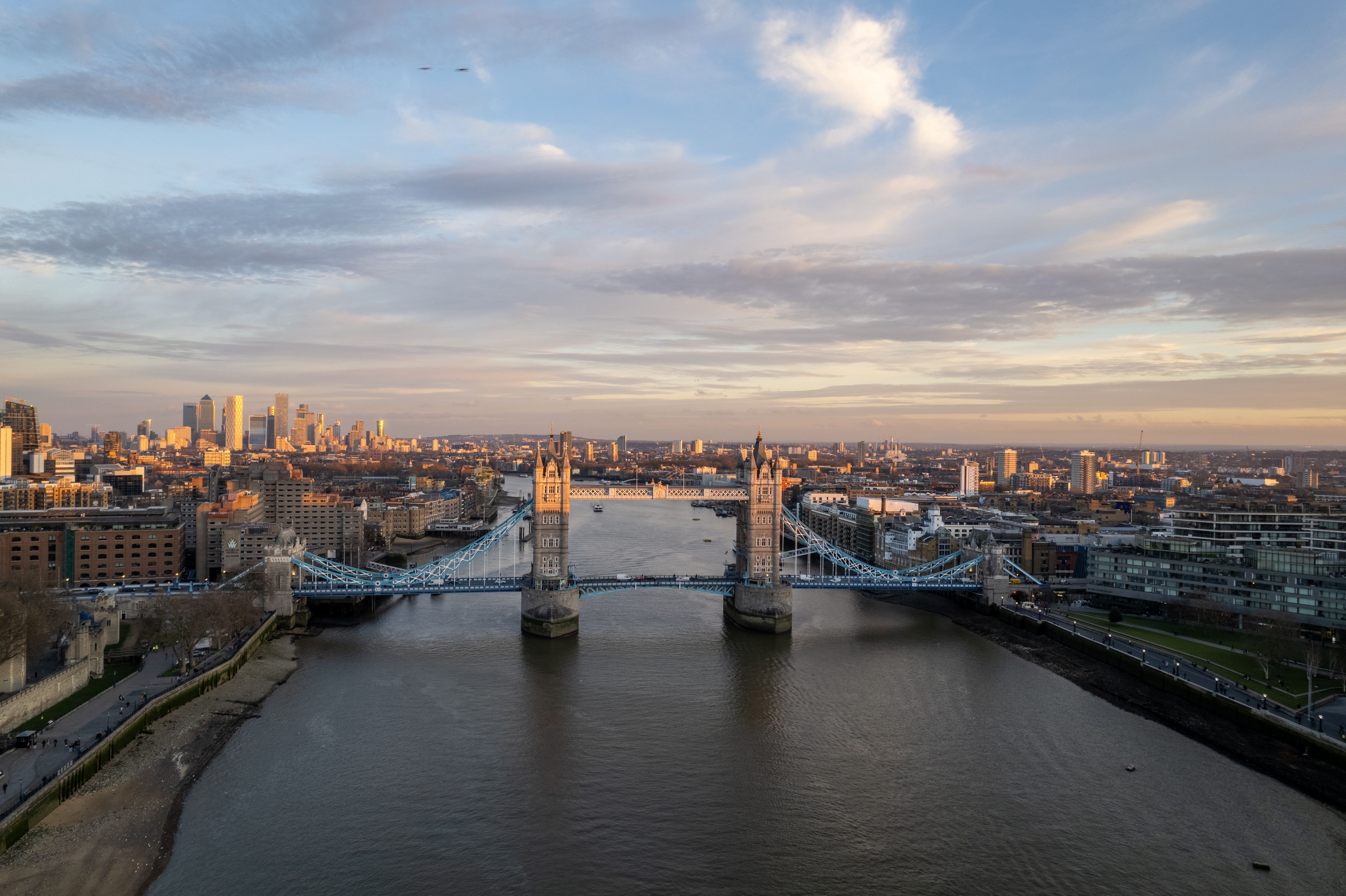 A breathtaking aerial shot of London's Tower Bridge with the city skyline at dusk.