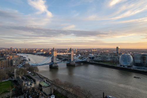 Free A stunning aerial view of London's Tower Bridge and cityscape at sunset. Stock Photo
