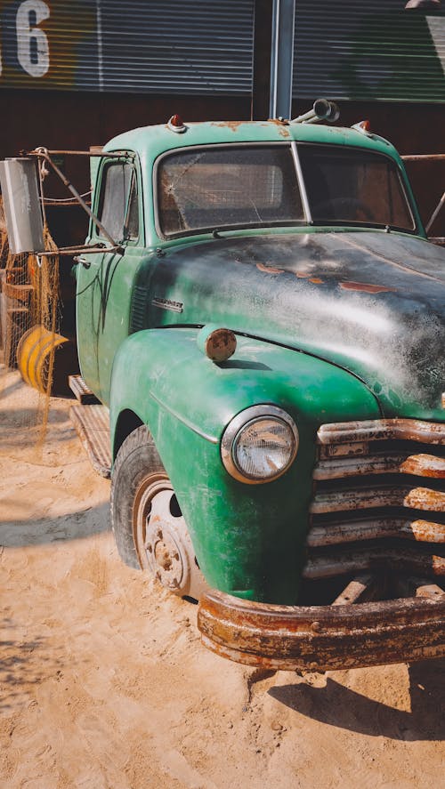 Old Green Car Parked on a Garage