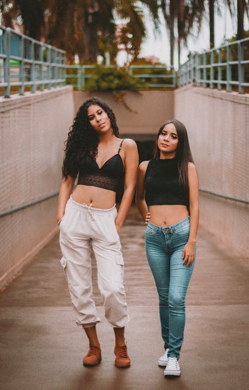 Free Two Women in Black Crop Top Posing on a Passage Stock Photo