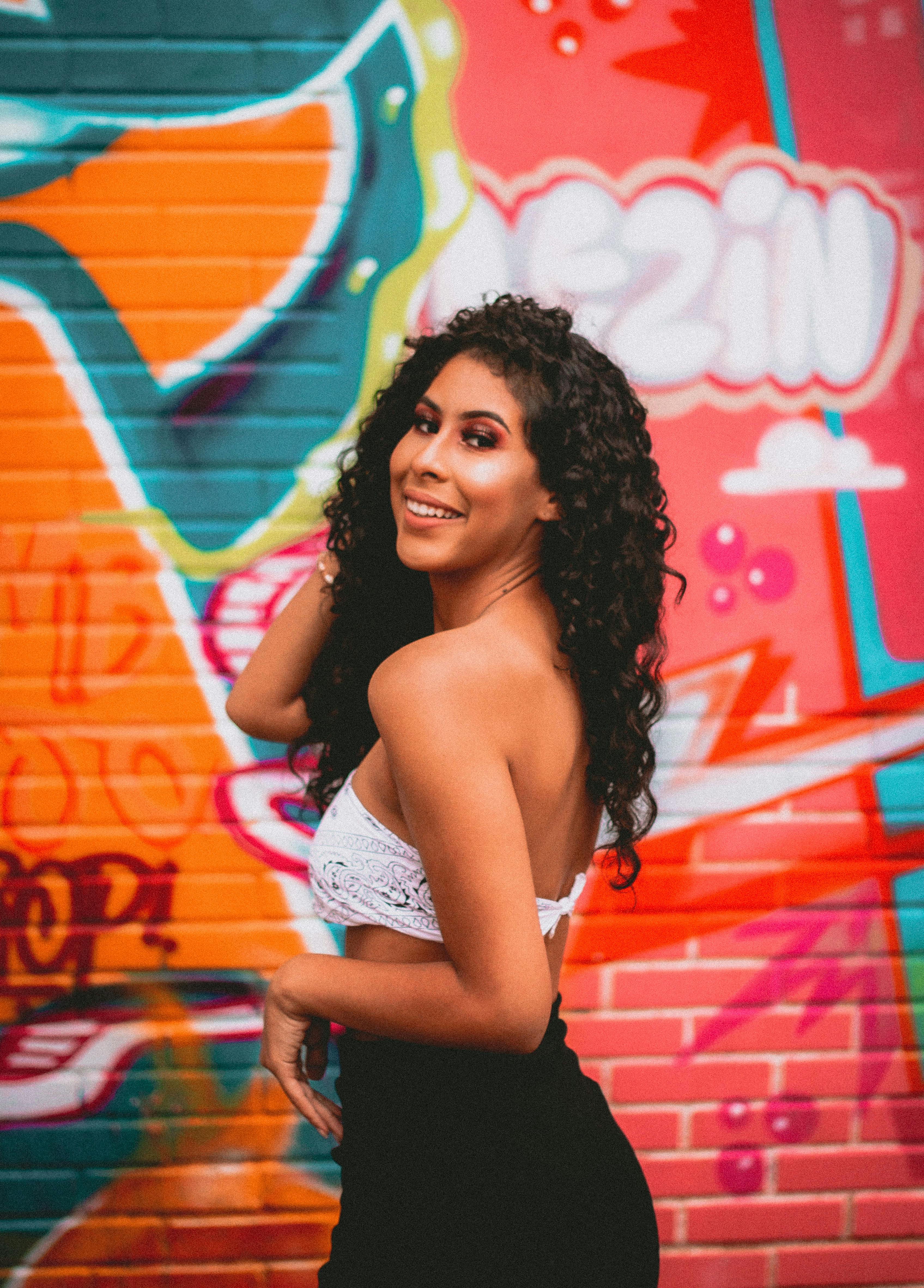 smiling woman posing in white bandana tube top