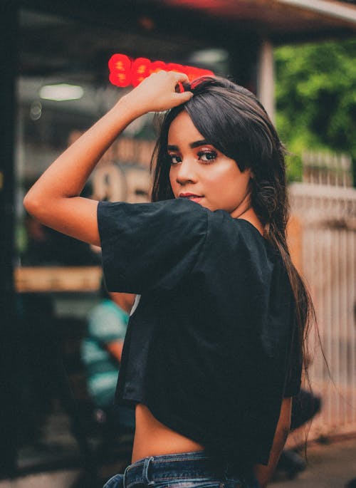 Woman Posing Hand on Her Hair in Black Crop Top Shirt