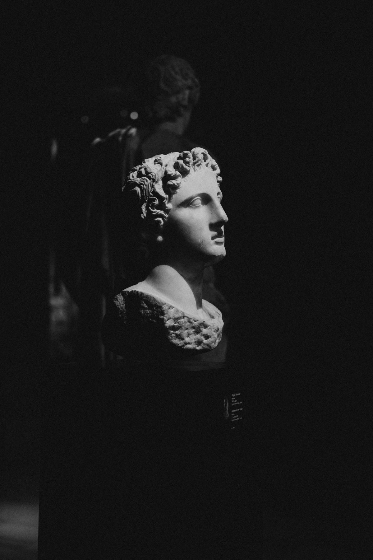 Classical marble statue in dramatic dark light