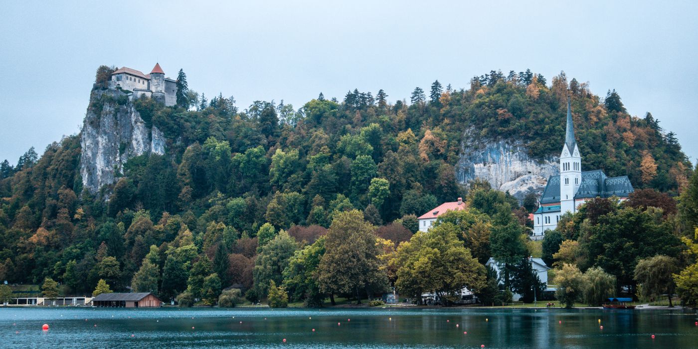 Aerial view of Lake Bled with island church and castle in the Slovenian Alps