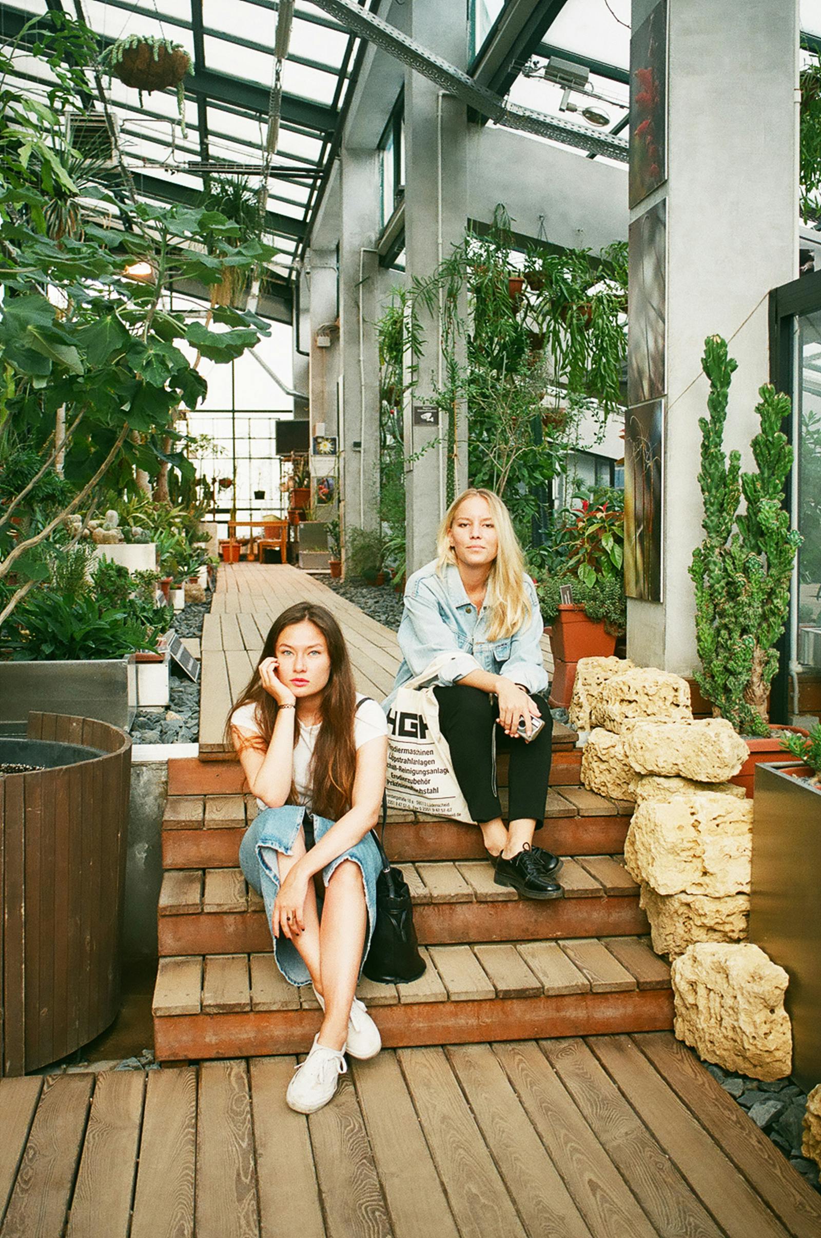 photography of women sitting on wooden stairs