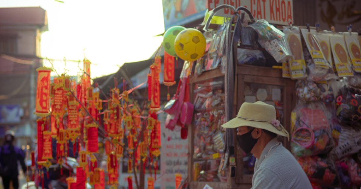 Photo by Sơn Đinh A street market vendor selling goods and decorations on a bustling outdoor market street.