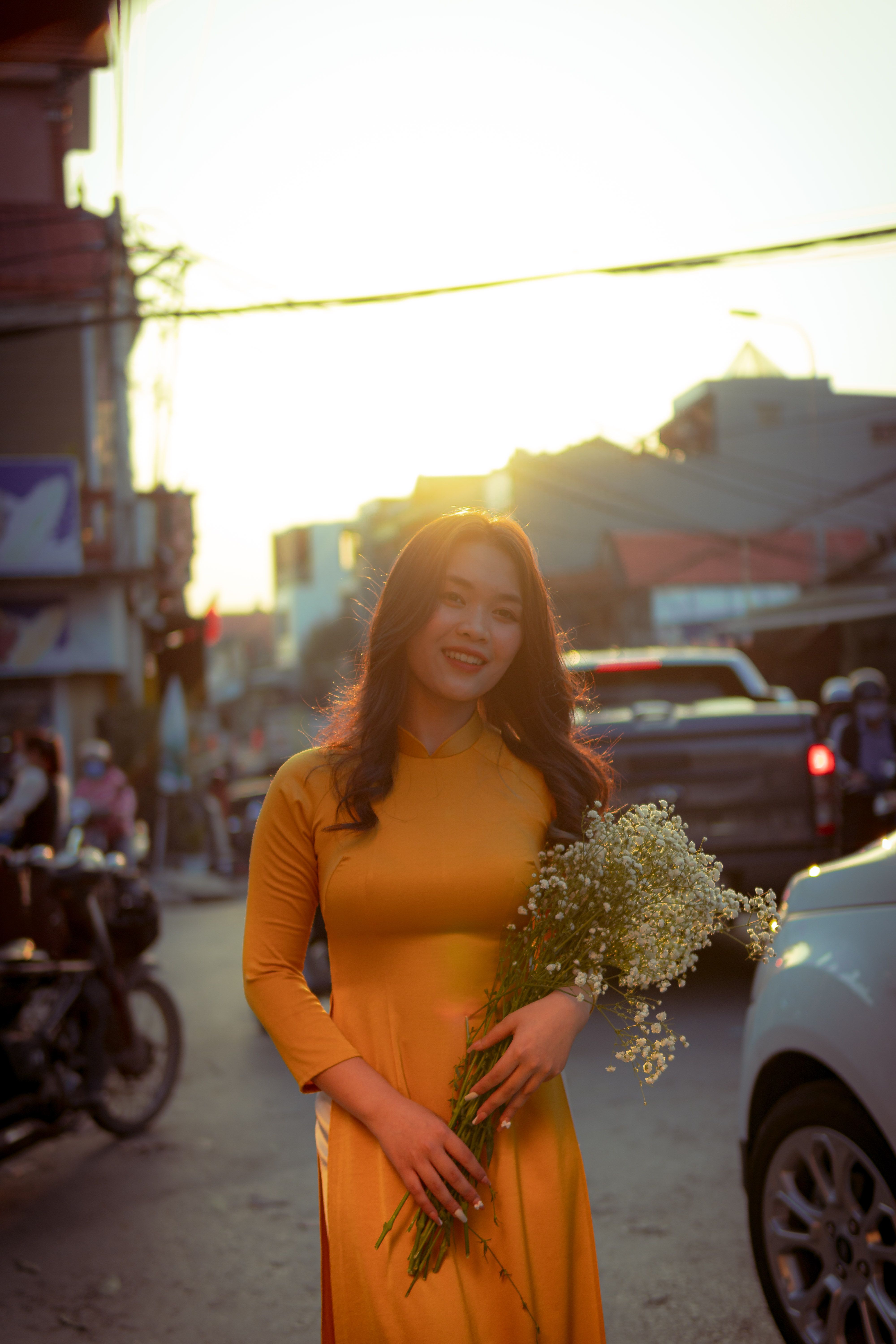 A Woman in Yellow Dress While Holding Flowers · Free Stock Photo