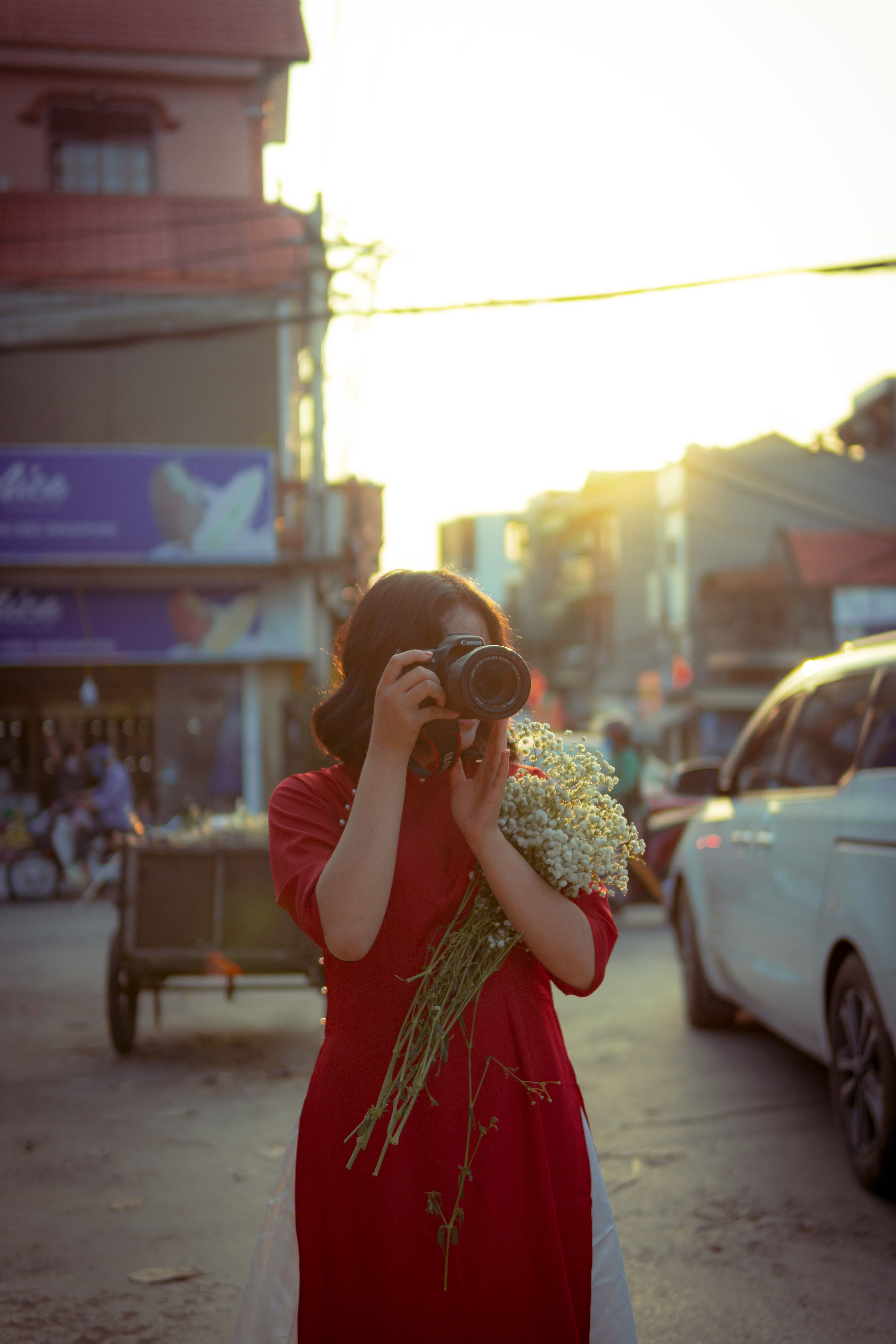 Woman in Red Dress Taking Photo of a City Street · Free Stock Photo