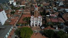 Drone capture of Guatapé's iconic church and surrounding townscape in Colombia.
