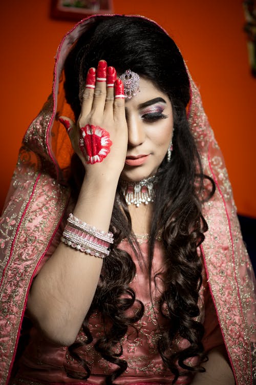 Woman in Red and Brown Floral Dress and Veil