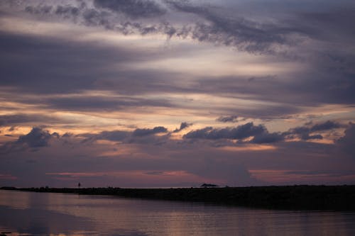 Dramatic Sky over River at Dawn