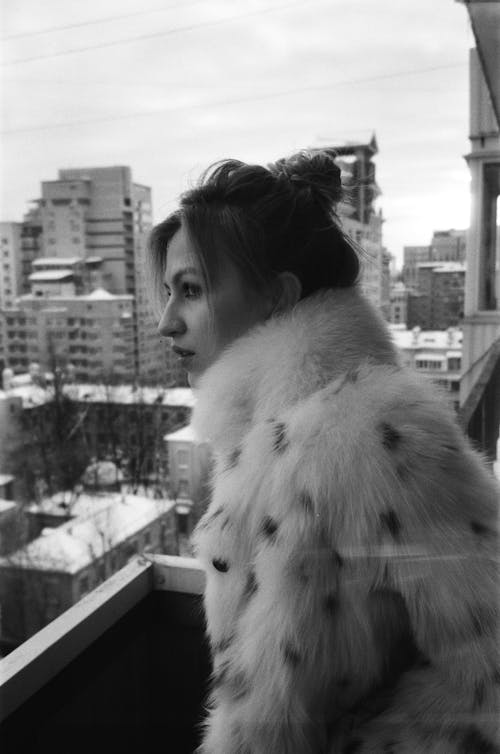 Woman in Fur Coat on Balcony