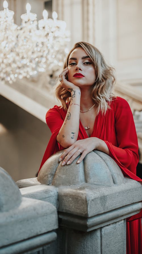 Woman in Red Dress Standing on the Stairs 