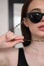 Woman Holding the Sunglasses Chain 