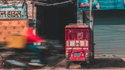 Free Motion blur of a scooter speeding past a vibrant street scene in Patna, India. Stock Photo