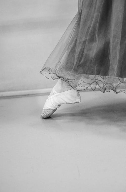 Free Grayscale Photo of a Foot with Pointe Shoes Stock Photo
