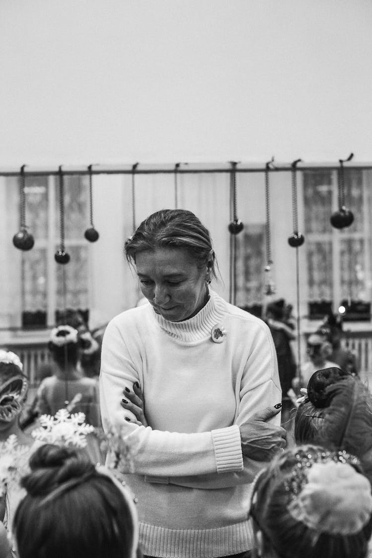 Photo Of A Woman With Cross Hands Looking To The Crowd