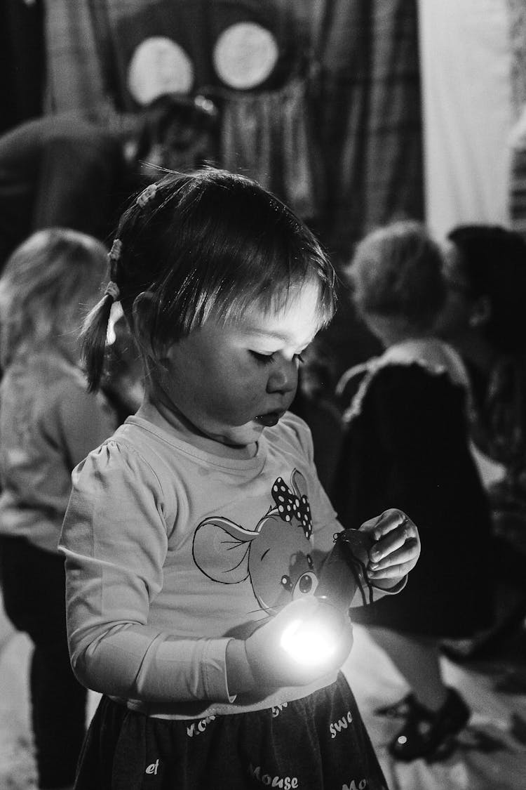 A Girl Holding A Flashlight