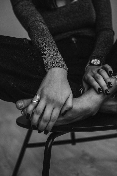 Grayscale Photo a Sitting Woman Holding Her Toes