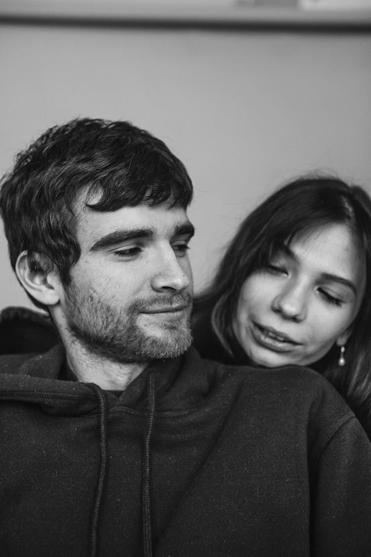 Young Bearded Man Looking At Woman Standing Behind His Shoulder