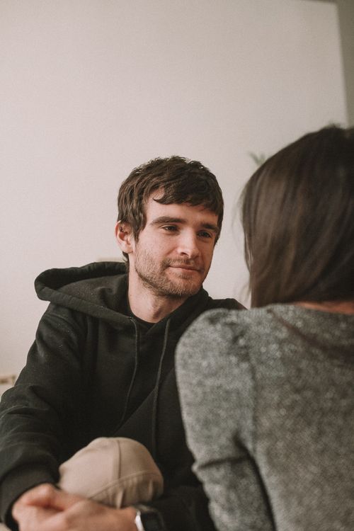 Free A couple having a candid and intimate conversation in a cozy indoor setting. Stock Photo