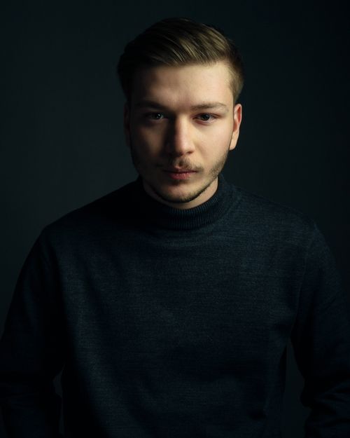 Free Moody portrait of a young man with facial hair wearing a turtleneck. Stock Photo