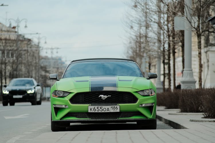 Green Ford Mustang Car On A City Street 