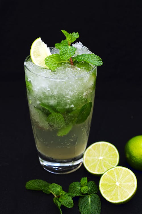 Free Clear Drinking Glass of Mojito with Mint Leaves and Sliced Lime Stock Photo