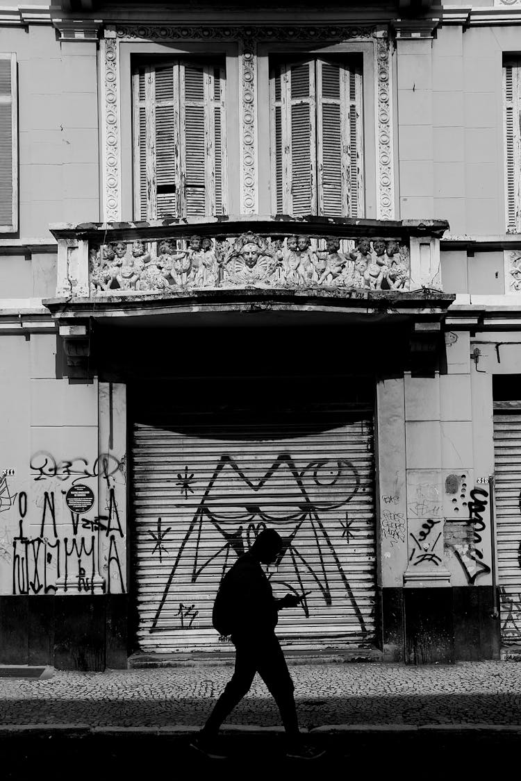 Person Walking Near Building With Tags