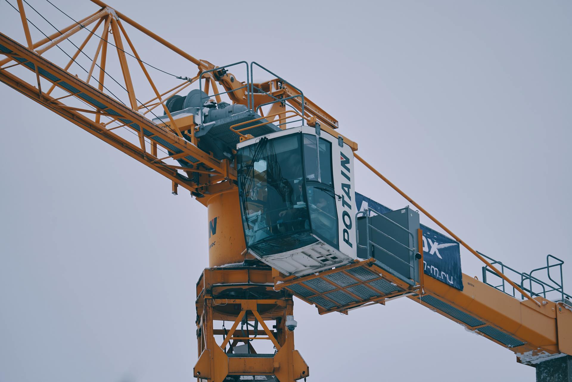 Photograph of an industrial tower crane operating against a winter sky in Moscow.