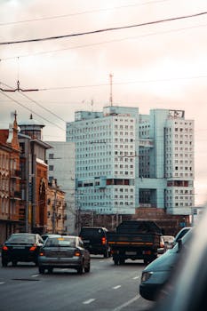 Cars driving down a busy street in Kaliningrad with modern and historic buildings.