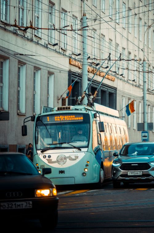 Free Tram navigating through Kaliningrad street, surrounded by cars. Captured during the day, showcasing urban transport. Stock Photo