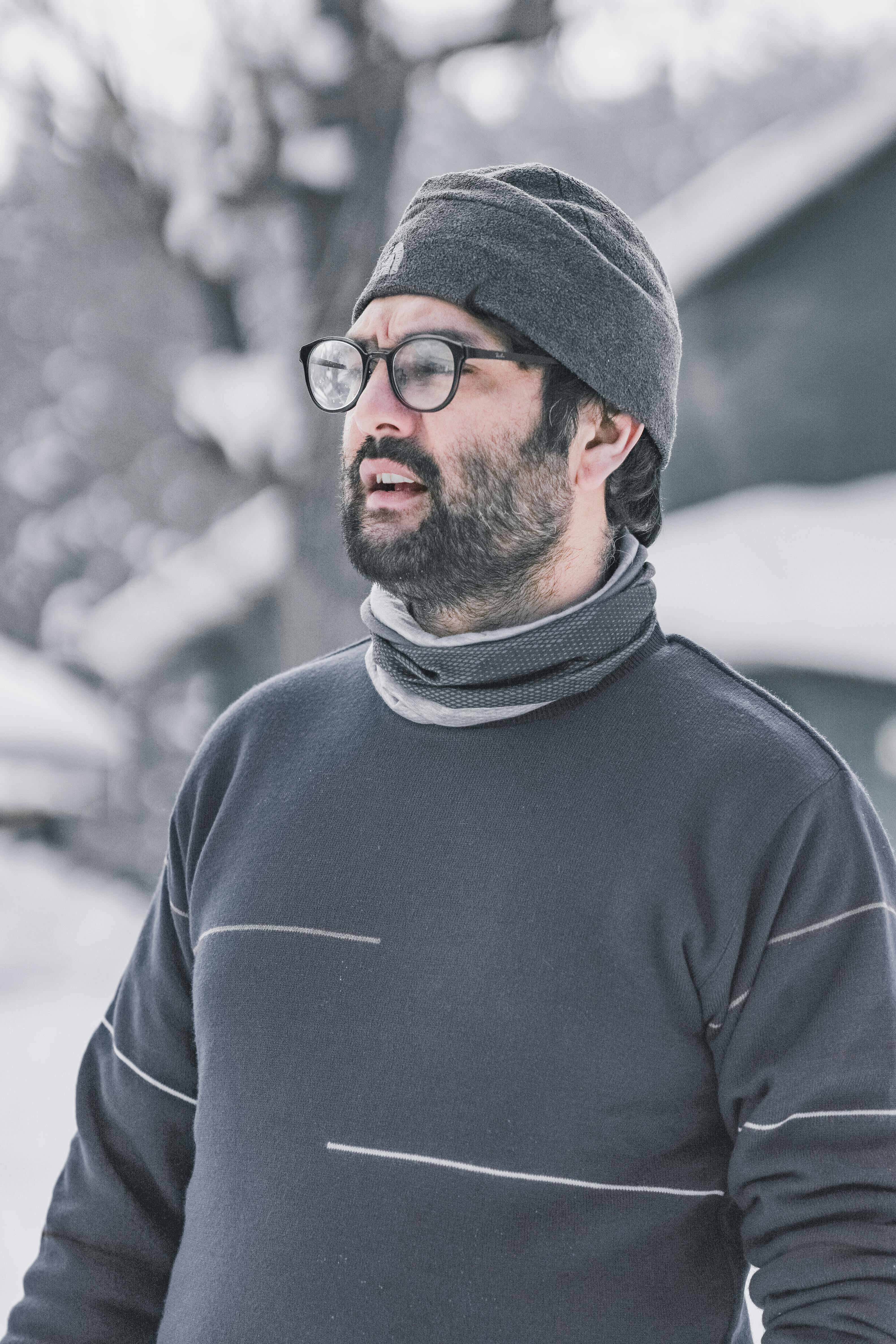 Prescription Goggle Inserts - Portrait of a bearded man wearing glasses and winter attire in snowy Gulmarg.