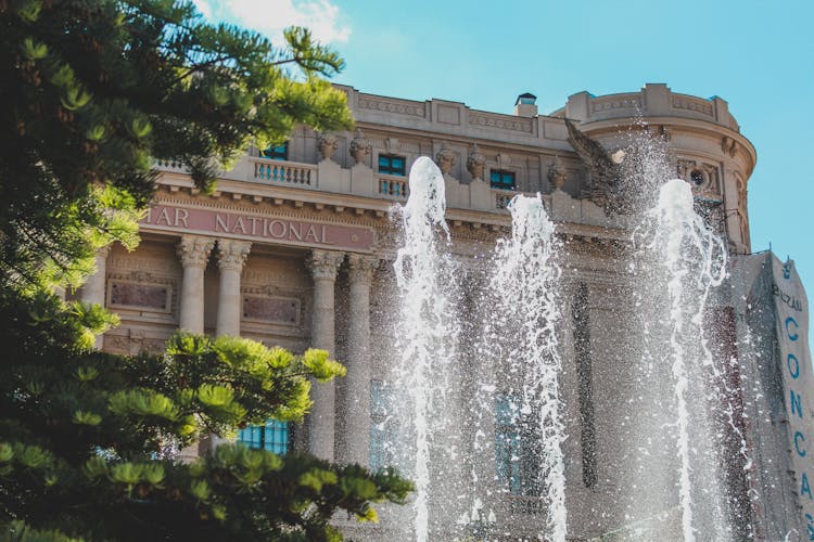 A Water Fountain In Front Of The Concrete Building