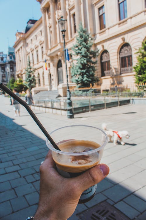 Person Holding a Cup of Iced Coffee