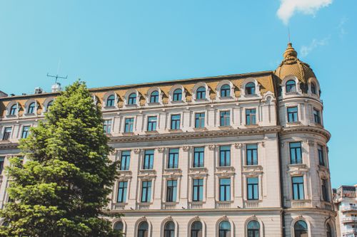 Free A historic urban building under a clear blue sky, highlighting architectural design. Stock Photo