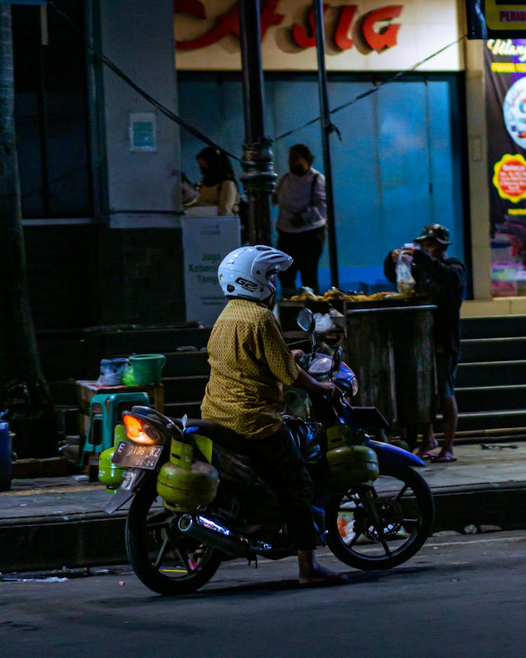 A Person Riding A Motorcycle At Night