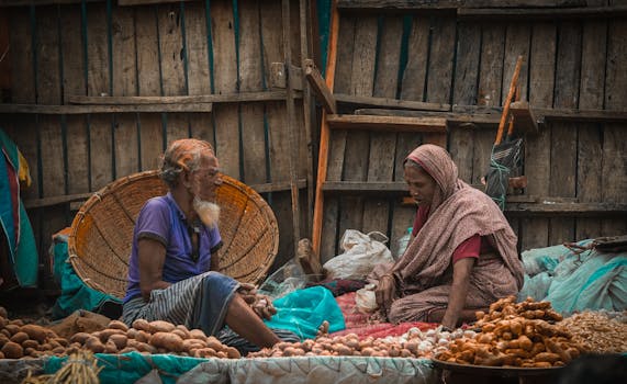 Two vendors at a market in Dhaka, Bangladesh, selling fresh produce.