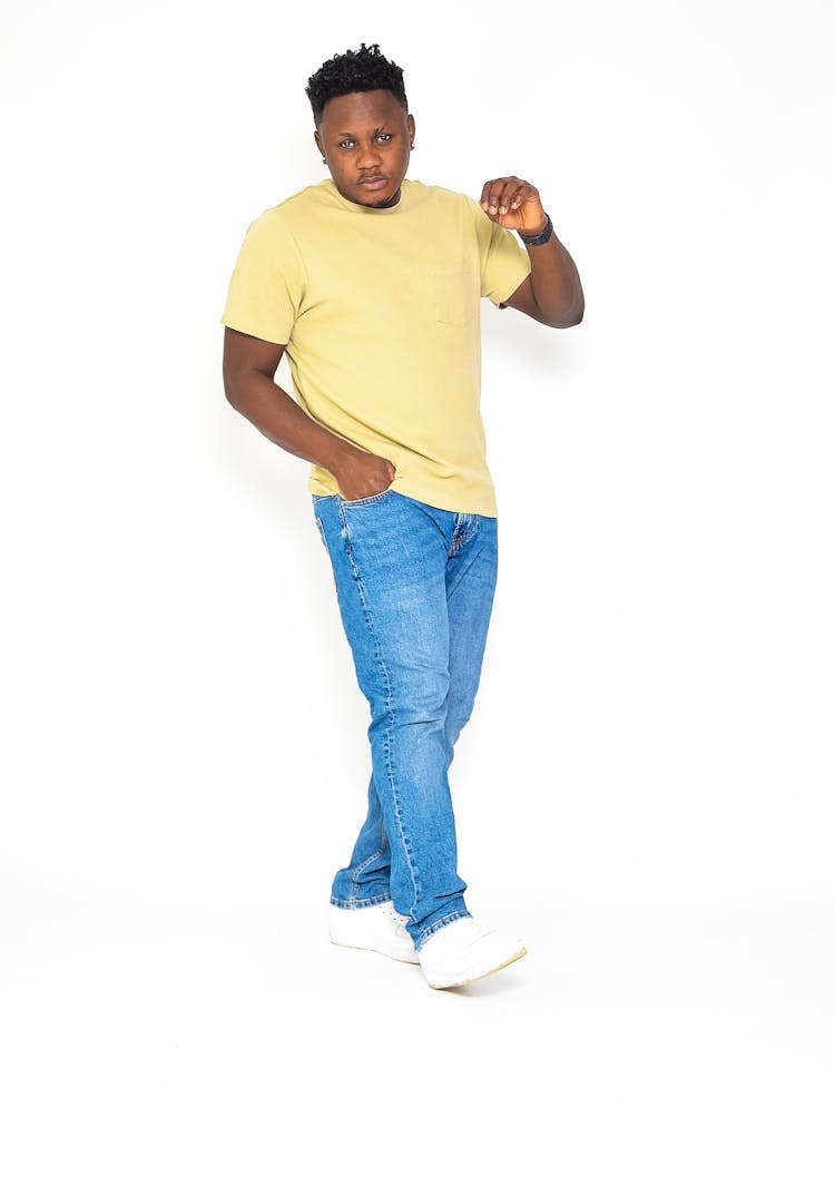 A Man In Yellow Shirt And Jeans 