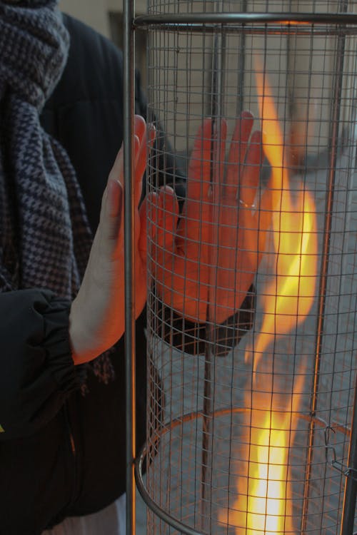 Woman Warming her Hands by the Fire 