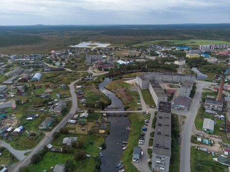 Sweeping aerial view of Lovozero village in Murmansk Oblast showcasing its rural landscape and architecture.