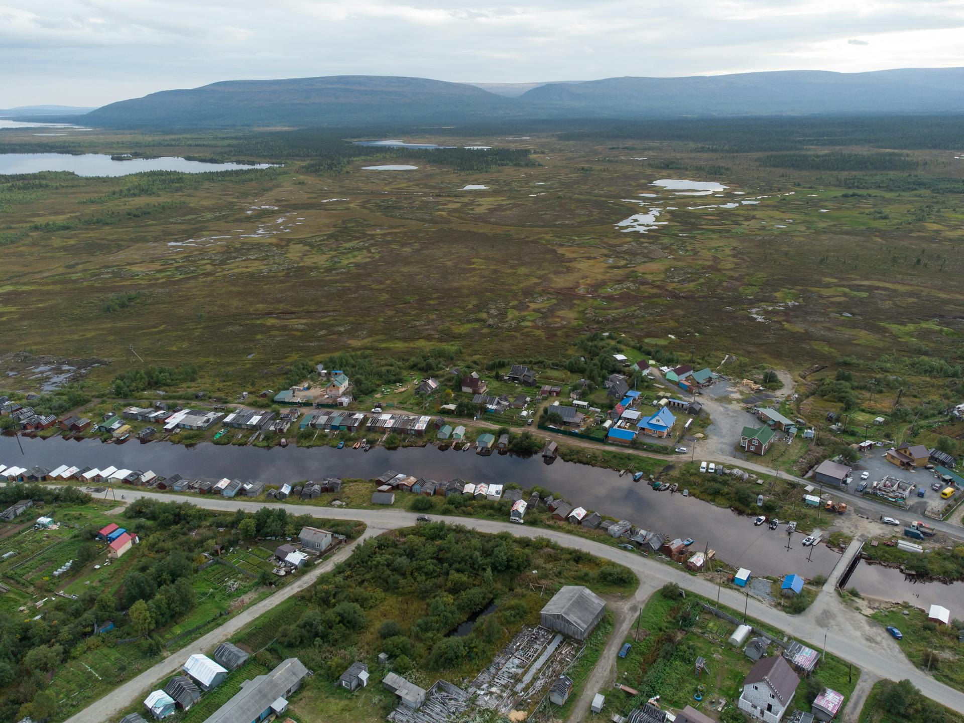 Aerial shot of Lovozero village in Murmansk region, showcasing landscape and waterway.