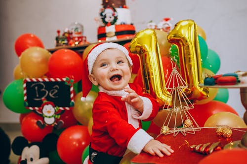 A Happy Little Boy in a Santa Claus Costume