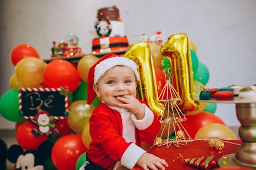 A Baby Boy Wearing a Santa Hat 