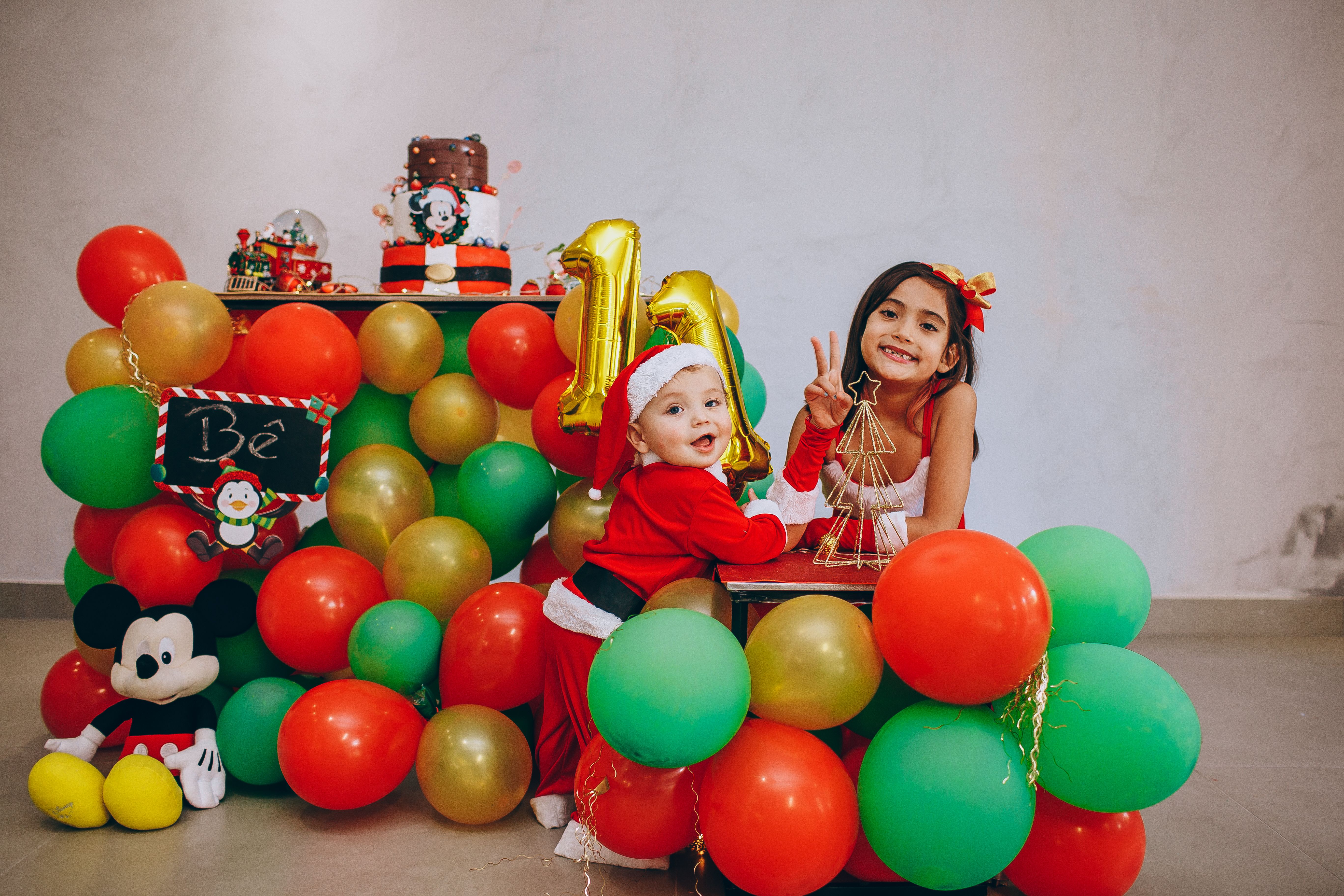 Children having fun at a colorful first birthday party with Mickey Mouse theme.