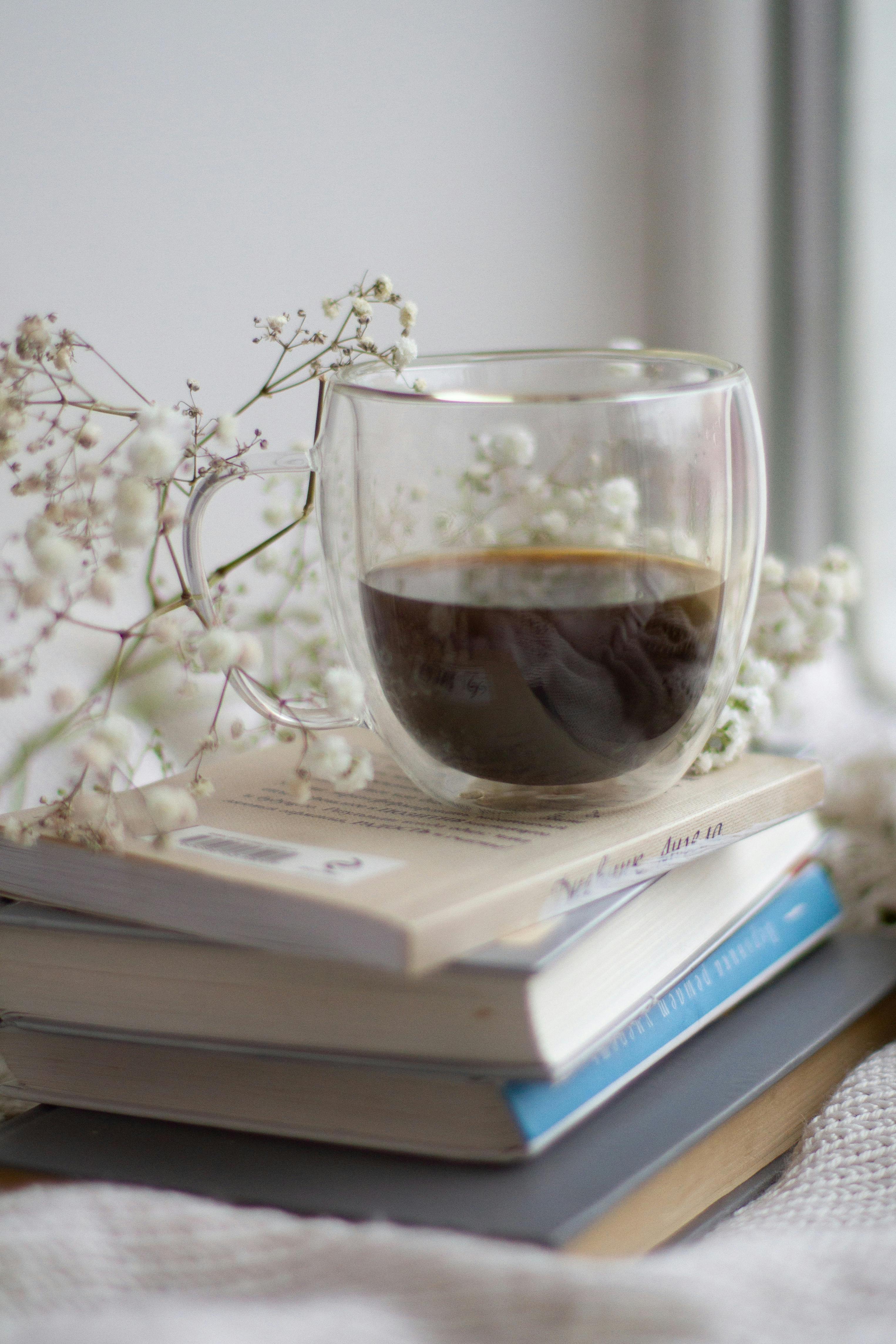 a cup of coffee on a stack of books