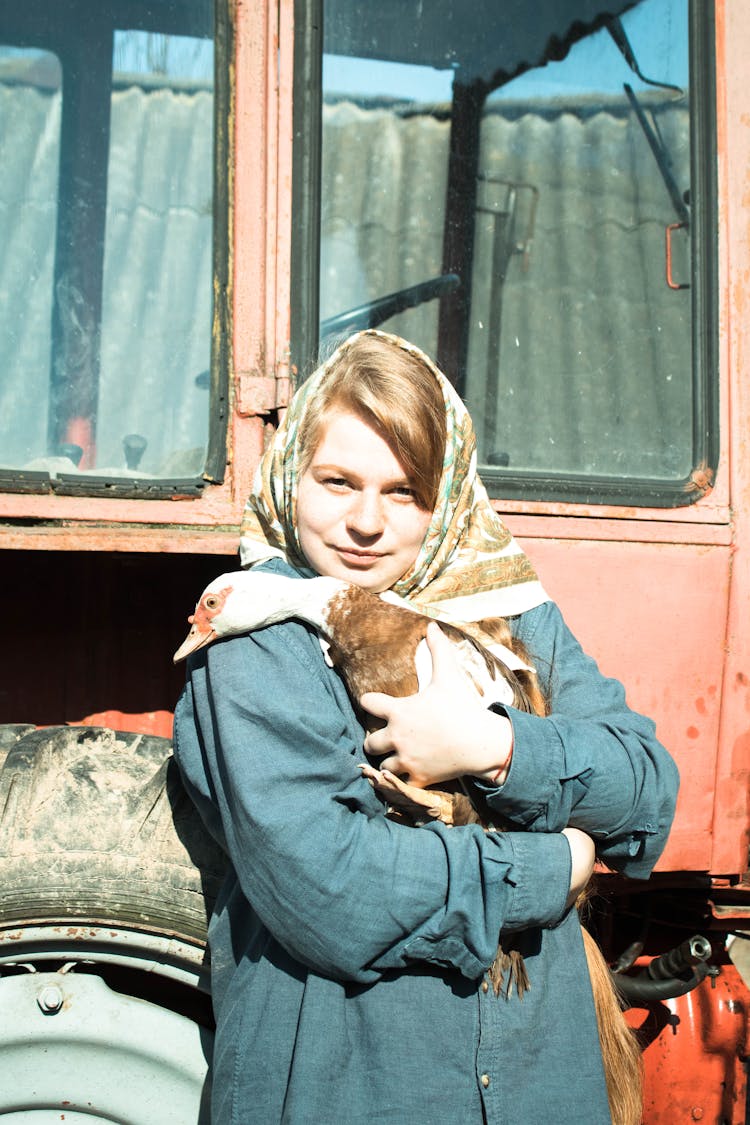 Woman With Headscarf Holding Duck