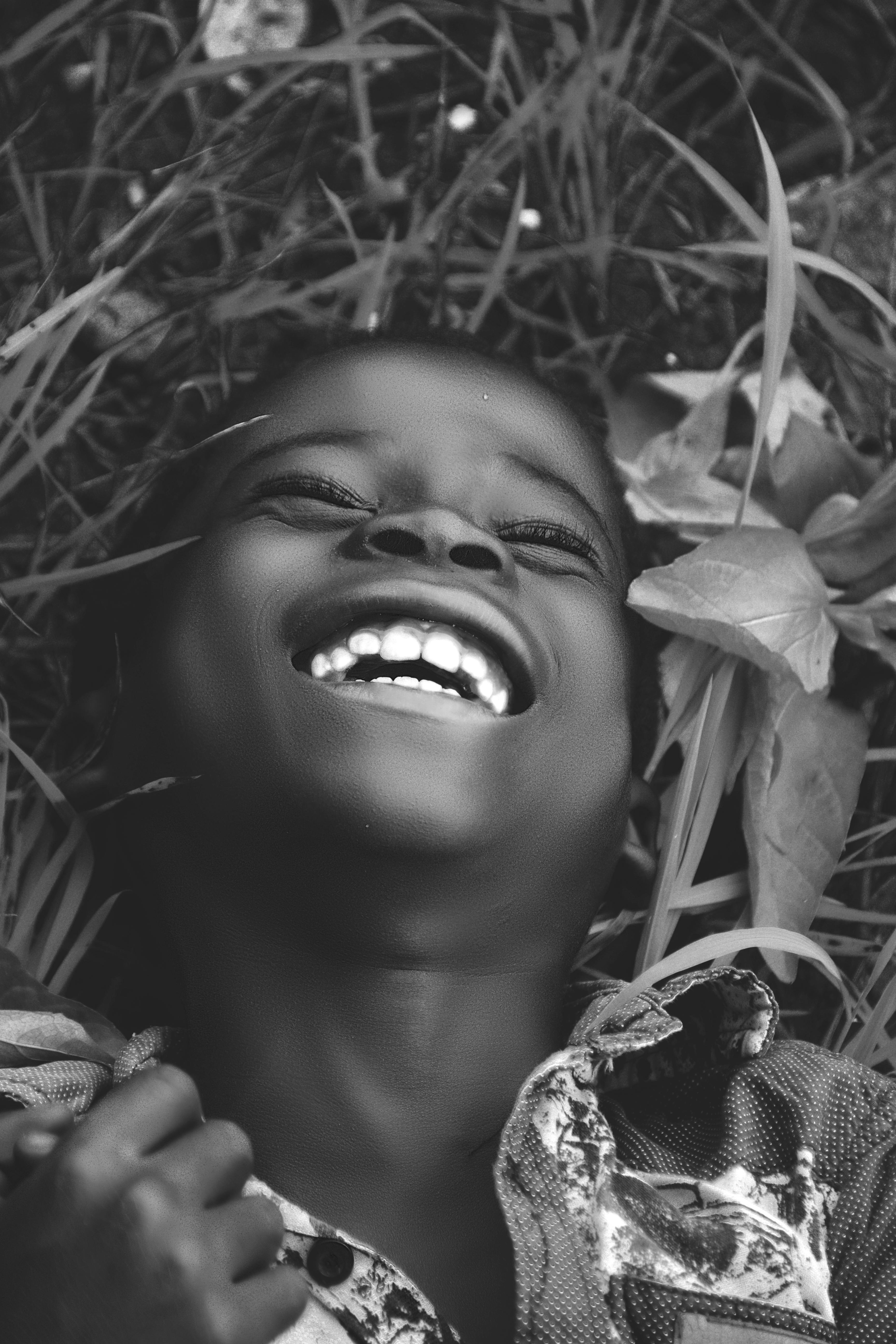 grayscale photo of a smiling boy