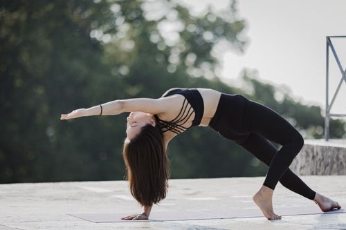 Free Woman practicing yoga outdoors in Regensburg, Germany, showcasing strength and flexibility. Stock Photo